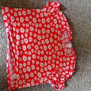 A Monki xs with a red bace and yellow and white flowers